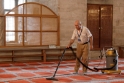 Vacuuming the mosque carpets